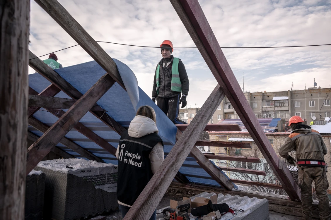 Repair work on the roof of an apartment building in the village of Pryshyb, Kharkiv Oblast, 2023 