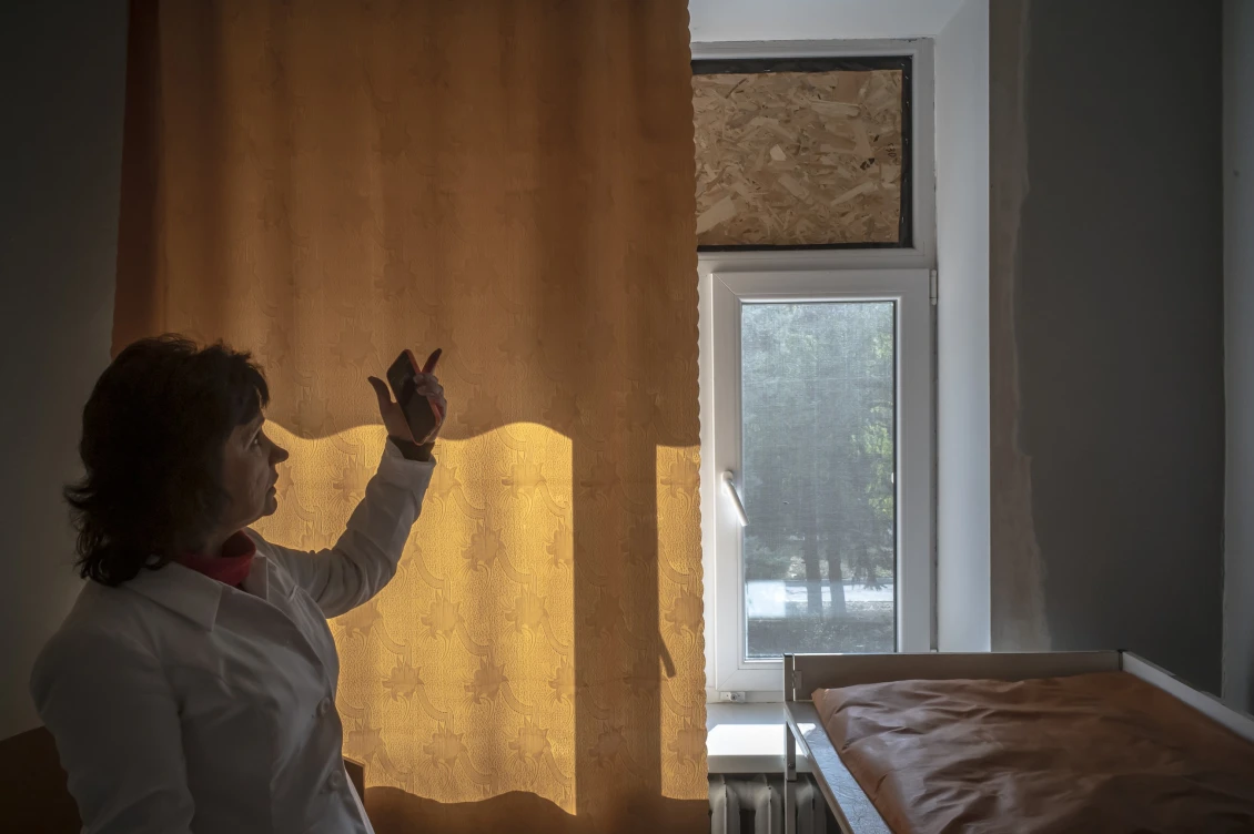 A labour protection engineer shows the consequences of one of the attacks. Shelling has damaged windows and doors in the facility. 
