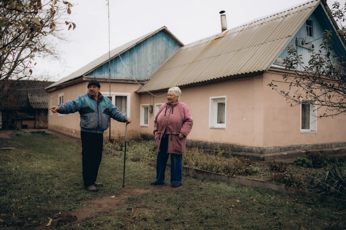The Kononenko family in front of their house. The family believe that they are fortunate because the neighbouring houses were burned down as a result of the fighting.