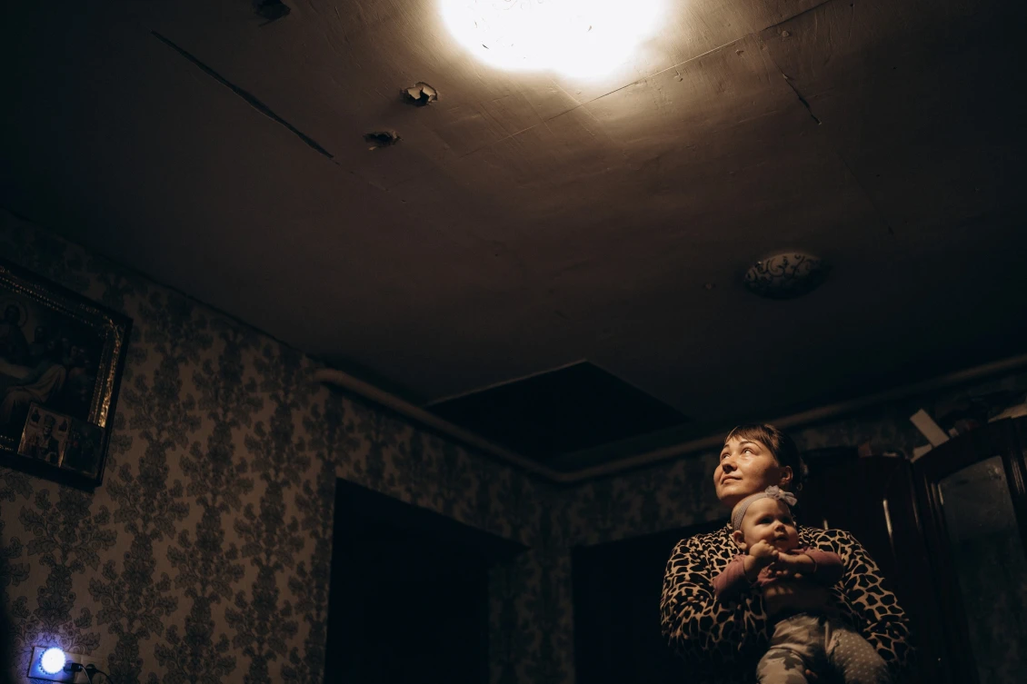 The ceiling in the living room of a large family is riddled with fragments from shells that exploded near their home.