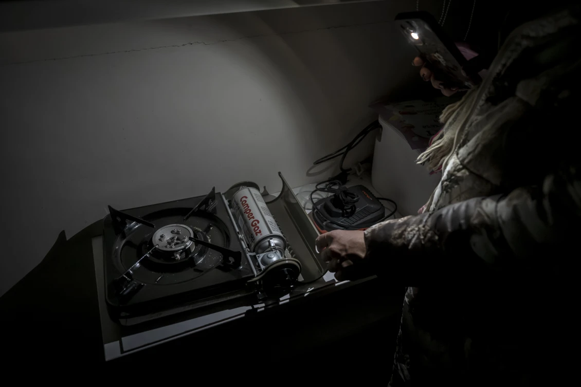 A camping gas stove used to heat food and prepare simple meals inside the apartment, as electricity is unavailable for most of the day