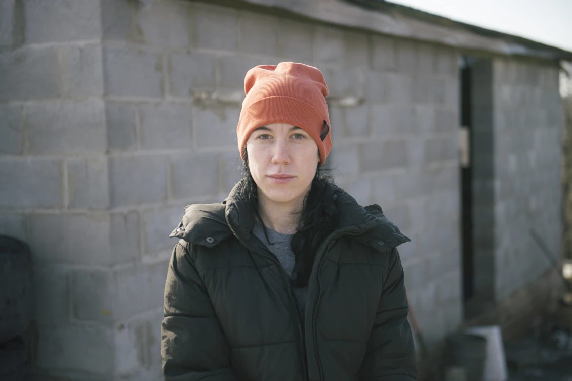Oleksandra in front of her temporary home 