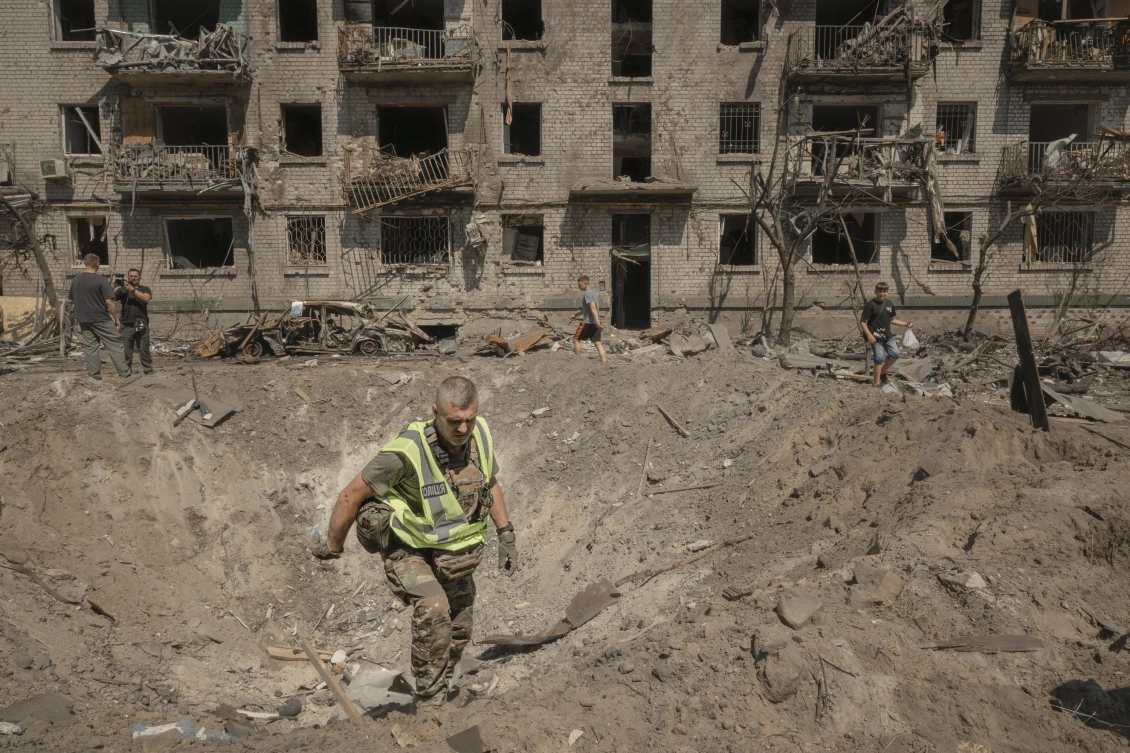 A blast crater in front of a residential block in the Darnytskyi neighbourhood