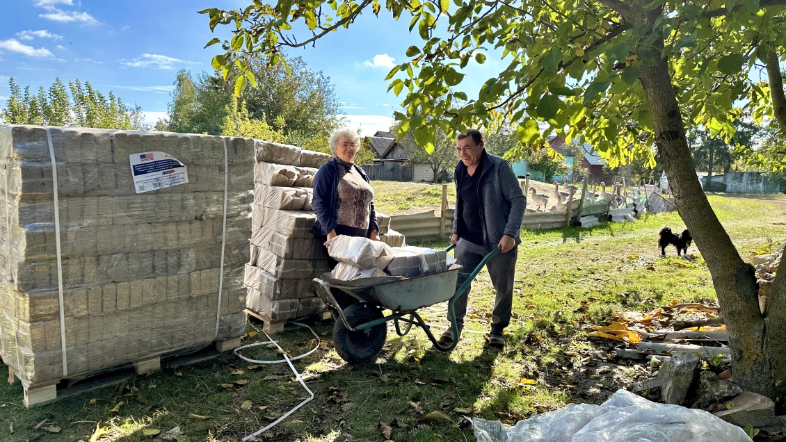 Halyna and Mykola transporting fuel briquettes